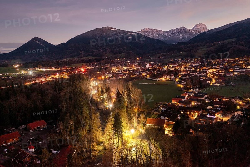 Illuminated town at dusk, surrounded by mountains and forests, creates a cosy atmosphere, Waldadvent event, Bad Feilnbach