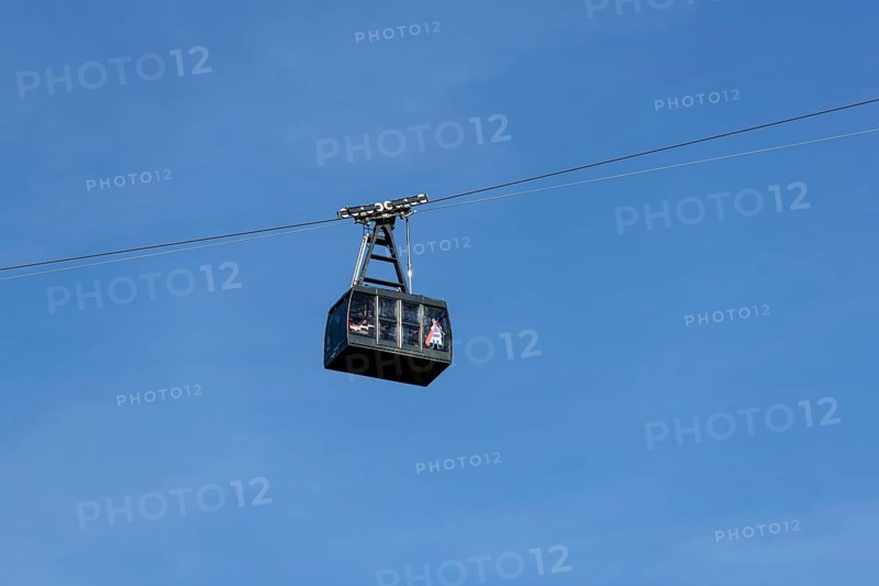A cable car cabin floats high in the clear blue sky, Tegelbergbahn, Schwangau, Ostallgäu, Allgäu, Swabia, Upper Bavaria, Bavaria, Germany, Europe