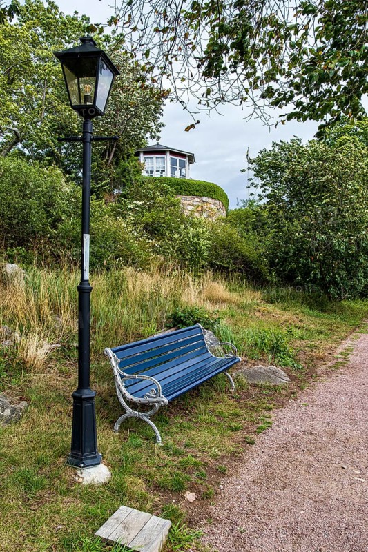 Bench and lantern in the famous allotment garden colony of Brändaholm on the island of Dragsö in the archipelago of Karlskrona, Blekinge län, Sweden, Europe