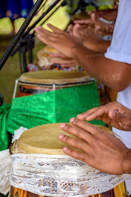 Hands playing several atabaque drums decorated with fabric being used during an Umbanda religious ceremony in Brazil Belo Horizonte, Minas Gerias, Brazil, South America