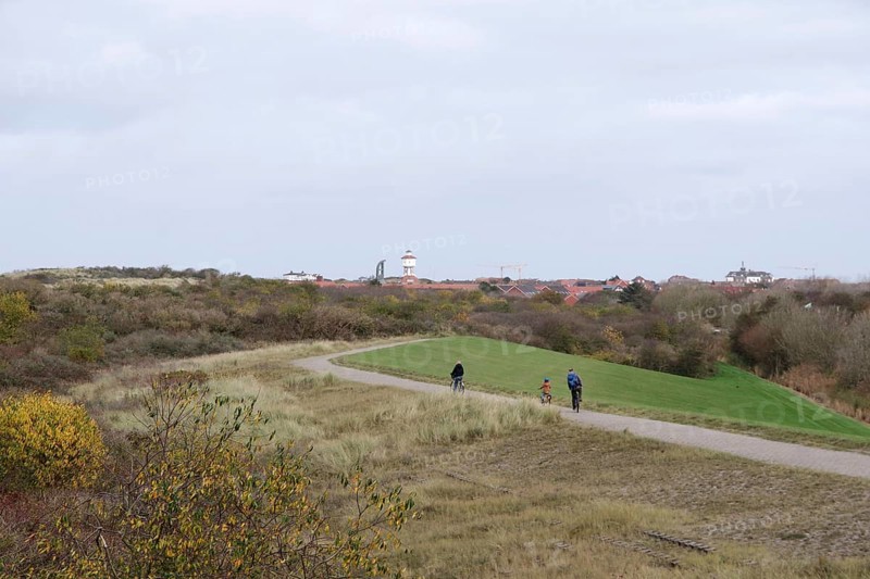 Landscape, dunes, water tower, Lower Saxon Wadden Sea National Park, Langeoog, Lower Saxony, Germany, View over the dune landscape in autumn on Langeoog. Holidaymakers cycling towards the town centre, Europe