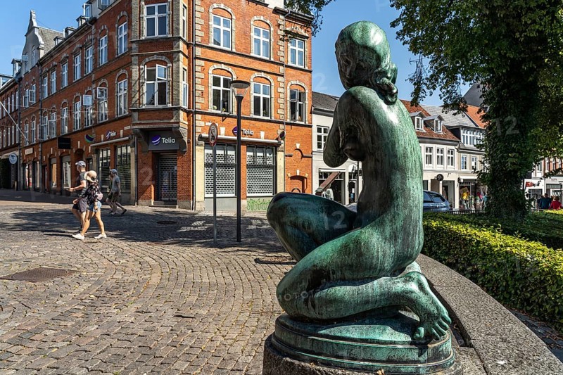 Statue of a young woman in the pedestrian zone of Svendborg, Denmark, Europe