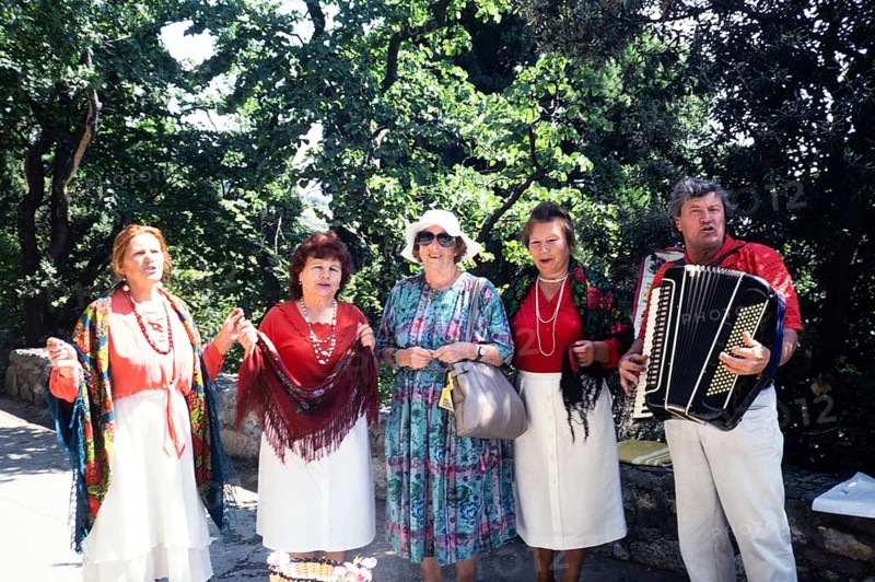 Accordion folk music group in front of Yalta, Crimea, Russia, 1997 Woman posing with the musicians, Europe