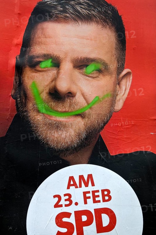 Denigration of a large poster for the 2025 federal election by the SPD with Axel Echeverria, Witten, North Rhine-Westphalia, Germany, Europe