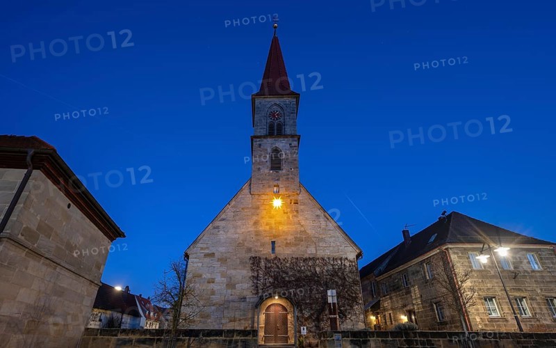 St Bartholomew's Church with poinsettia at dusk, Eschenau, Middle Franconia, Bavaria, Germany, Europe