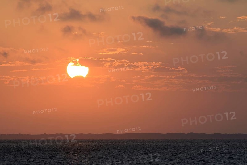 Sunset over the North Sea, on the horizon the contours of the island of Juist, Norddeich, Lower Saxony, Germany, Europe
