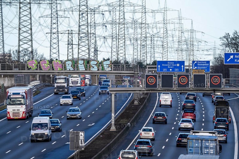 A57 motorway near Kaarst in the Rhine district of Neuss, view in the direction of the Kaarst motorway junction, heavy traffic, overhead power lines, along the motorway, North Rhine-Westphalia, Germany, Europe