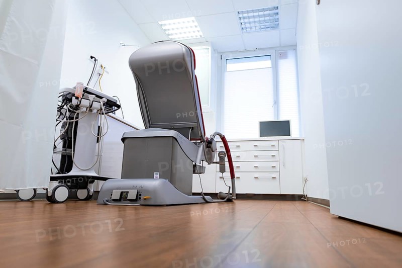 Modern medical treatment room with one chair and equipment, bright atmosphere, Urology, Germany, Europe