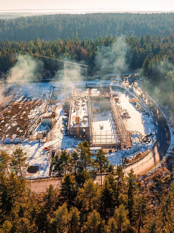 Snow-covered construction site in the forest with cranes and areas surrounding trees, new fire station, Oberhaugsett, district of Calw, Germany, Europe