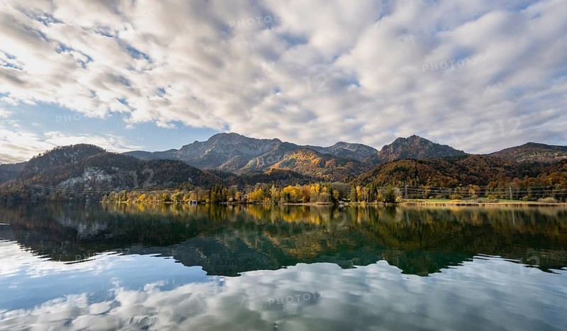 Autumnal mountain landscape with mountain peaks Herzogstand and Heimgarten, reflection in Lake Kochel, Upper Bavaria, Bavaria, Germany, Europe