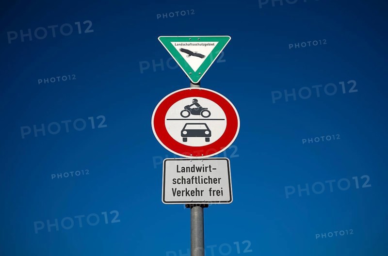 Traffic sign, landscape protection area, prohibition for motorbikes, also with sidecar, mopeds, mopeds as well as for motor vehicles and other multi-lane motor vehicles. Exception agricultural traffic free, in front of sky, blue, Stuttgart, Baden-Württemberg, Germany, Europe