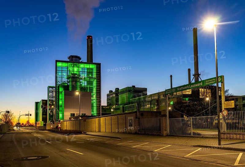 The Lausward combined heat and power plant in Düsseldorf, gas and steam turbine power plant, operated by Stadtwerke Düsseldorf and EnBW, in the harbour of Düsseldorf on the Rhine, green illuminated city window, the chimney of the Fortuna power plant unit, the power plant generates electricity, also traction current and district heating, North Rhine-Westphalia, Germany, Europe