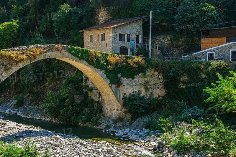 Santa Lucia Bridge, a medieval stone arch bridge over the Argentina River in Valle Argentina, Badalucco, province of Imperia, Liguria, Italy, Europe
