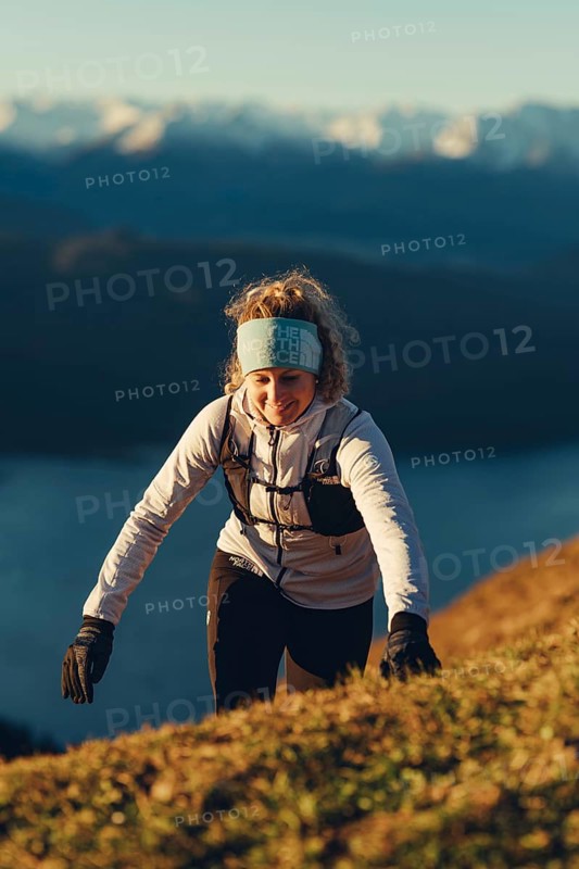 Trail running in autumn on the Jochberg on Lake Walchensee against the wonderful backdrop of the Alps, Bavaria, Germany, Europe