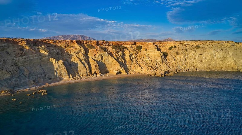 Rocky cliffs at sunset with calm water and natural beauty, drone shot, evening light, Paralia Agios Theodoros, Agios Theodoros Beach, southwest coast, Karpathos, Dodecanese, Greek Islands, Greece, Europe
