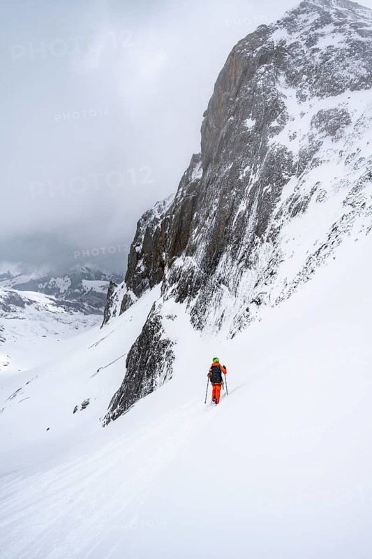 Ski tourer on a steep mountain slope, Snowy mountain landscape, Bernese Alps, Bernese Oberland, Switzerland, Europe