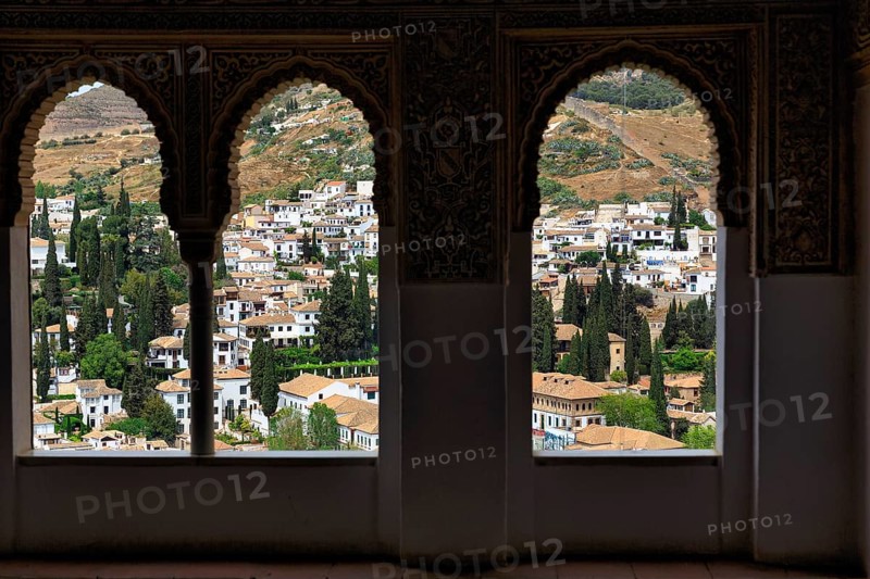 View of the city through three arabesque arched windows, Nasrid Palaces, Alhambra, Granada, Andalusia, Spain, Europe