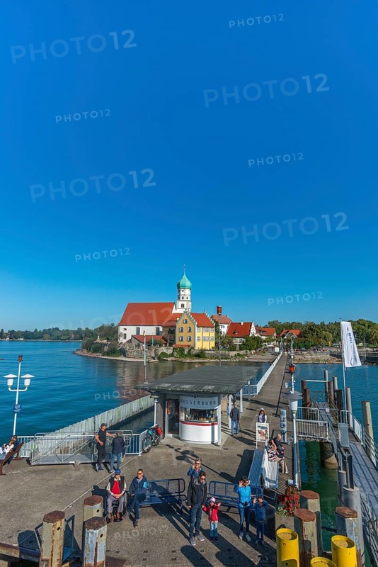 Moated castle, Lake Constance, kiosk, jetty, tourists, flag, parish church of St George, onion dome, Bavaria, Germany, Europe