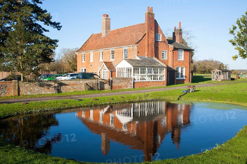 Traditional red brick farmhouse and farmyard water pond, Lux Farm, Kesgrave, Suffolk, England, United Kingdom, Europe