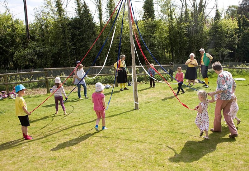 Children dance around a maypole at an English country festival, Shottisham, Suffolk, England, United Kingdom, Europe