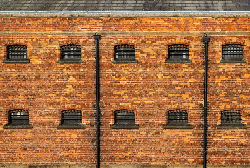Cell windows with bars, exterior of Victorian jail museum, Lincoln Castle, city of Lincoln, Lincolnshire, England, UK