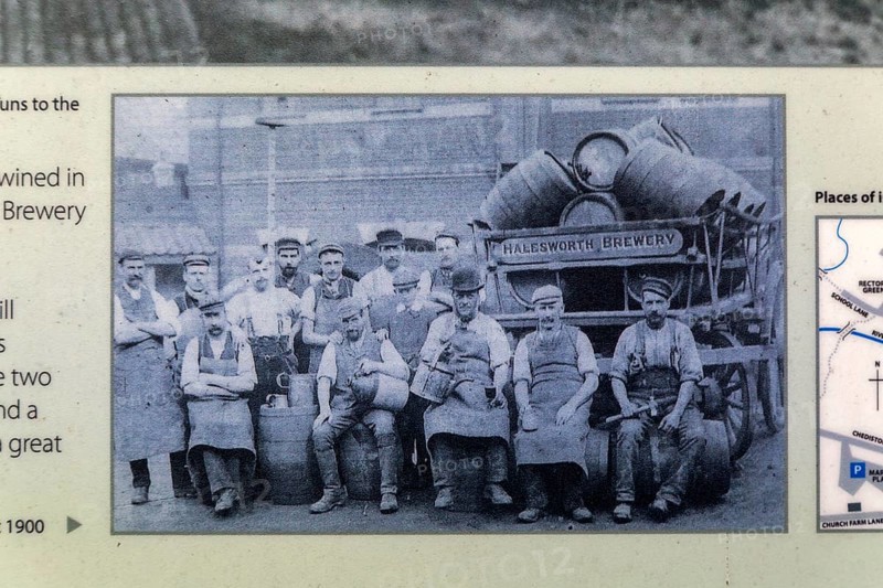 Old information notice with historic photo of male men brewery workers, Halesworth, Suffolk, England, UK