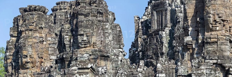 Panoramic image of giant stone-carved faces of the Bodhisattva Lokeshvara, also known as Avalokiteshvara, Bayon Temple, Angkor Thom, UNESCO World Heritage Site, Angkor Wat, Siem Reap, Cambodia, Asia