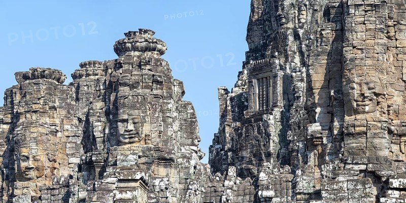 Panoramic image of giant stone-carved faces of the Bodhisattva Lokeshvara, also known as Avalokiteshvara, Bayon Temple, Angkor Thom, UNESCO World Heritage Site, Angkor Wat, Siem Reap, Cambodia, Asia