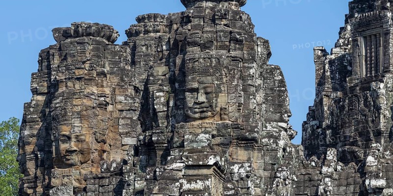 Panoramic image of giant stone-carved faces of the Bodhisattva Lokeshvara, also known as Avalokiteshvara, Bayon Temple, Angkor Thom, UNESCO World Heritage Site, Angkor Wat, Siem Reap, Cambodia, Asia