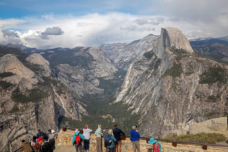 Yosemite National Park, California - Tourists viewing Half Dome in Yosemite National Park from Glacier Point
