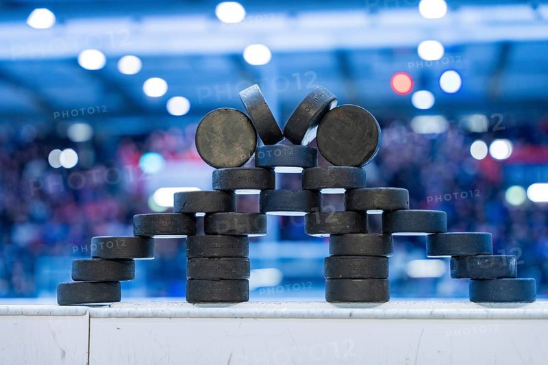 Stack of ice hockey pucks artfully arranged on the sidelines, Heilbronner Falken Vs Bietigheimer Steelers, Heilbronn, Germany, Europe