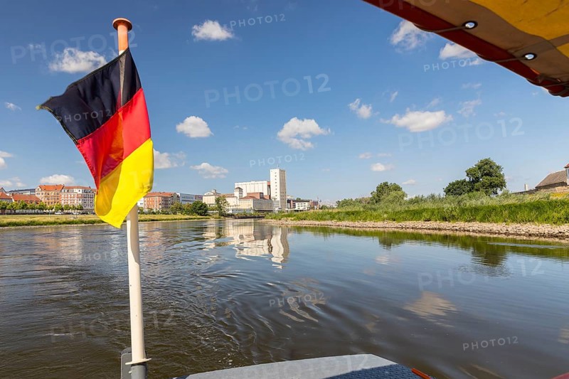 German flag on the ferry, in the background the city view with Elbe, Riesa, Saxony, Germany, Europe