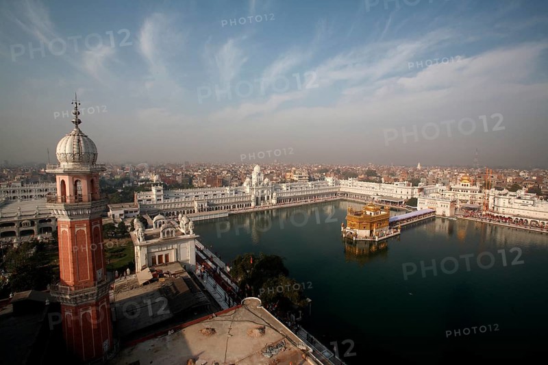 Aerial view of city and Harmandir Sahib or Darbar Sahib or Golden temple and Tower of Ramgarhia Bunga surrounded
