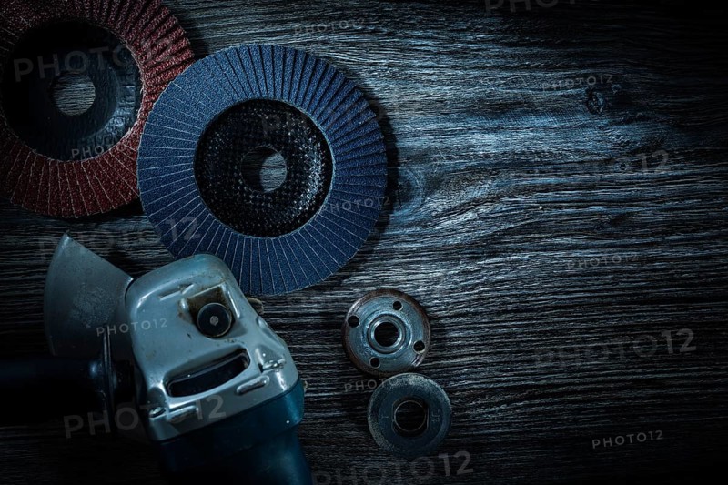 Angle grinder radial sanding discs on vintage wooden board