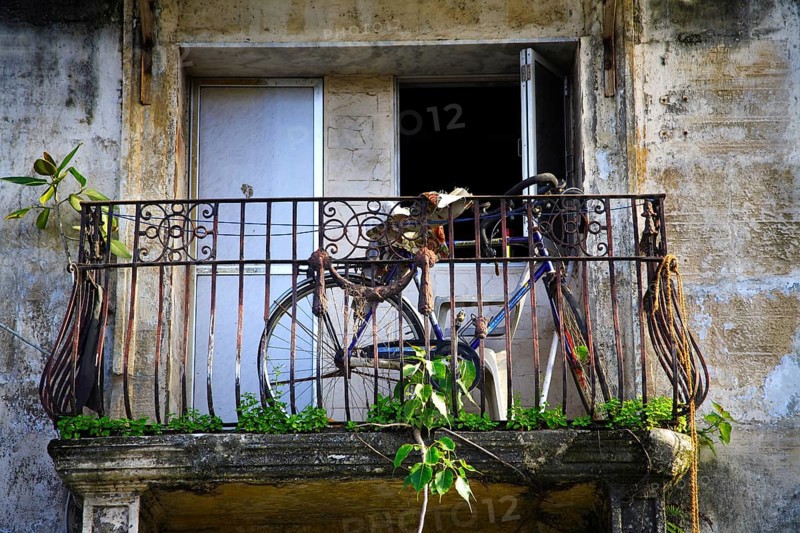 Bicycle in balcony of chawl, Lower Parel, Bombay Mumbai, Maharashtra, India 26-August-2009