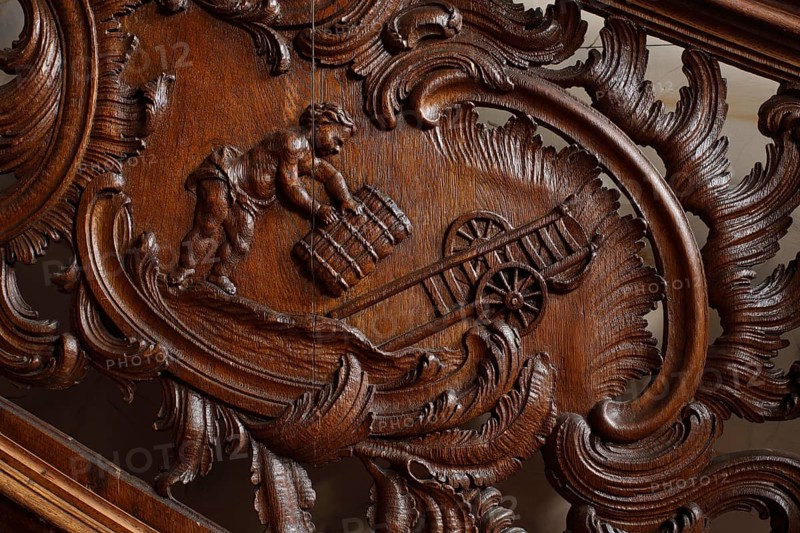 Residential building Zum goldenen Helm, cantilevered oak staircase, railings with picture cartouches. Depictions of putti at the clothmaker's: The transport
