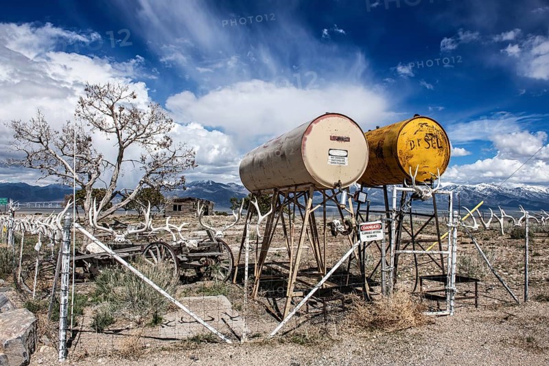 Truck stop with oil barrels and a fence of deer antlers, Highway 50, Loneliest Road in America, Ely, Nevada, USA, North America