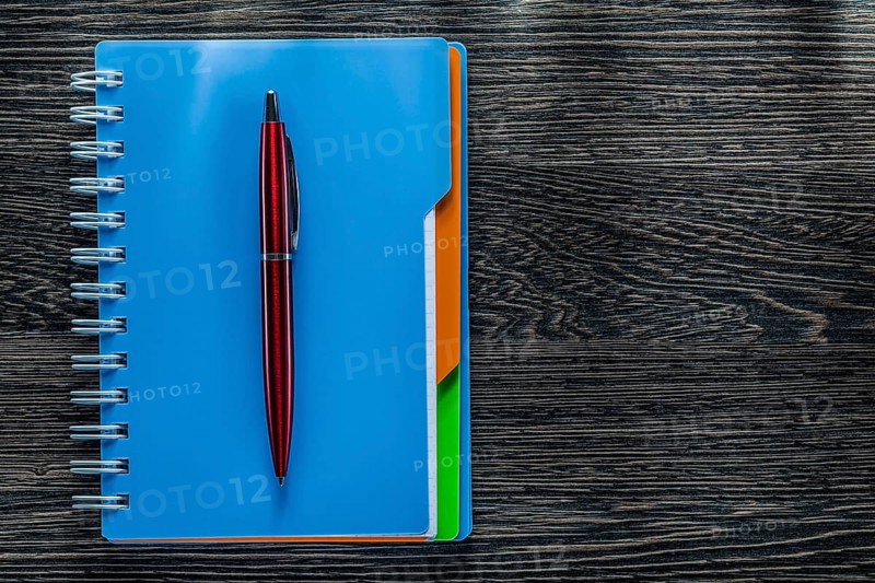 Biro pen notebook on vintage wooden board
