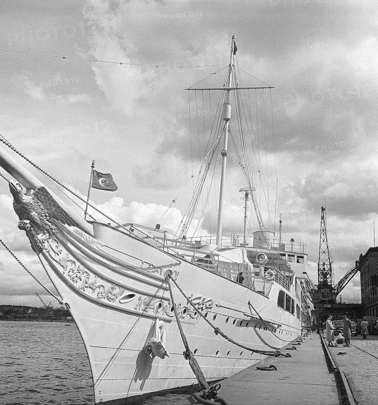 Ship in the harbour 1956. A Turkish passenger ship in Stockholm's harbour. A carved eagle adorning the bow. In 1956 the flag visible was the official flag of Turkey with a crescent moon and three stars, iconic symbols of Turkey originating from the traditions of the Ottoman empire. Kristoffersson ref BX68-12