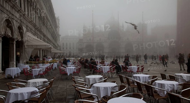 Italy Venice St Mark's Square -46 Café Lavena outdoor seating on a foggy November day behind St Mark's Basilica and Campanile