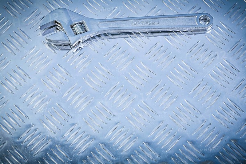 Adjustable tensioner on fluted metal background construction concept