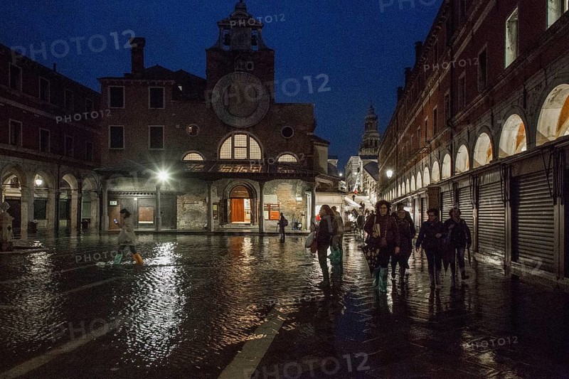Italy Venice Church of San Giácomo di Rialto -160 right Ruga dei Orési at high tide in the evening behind Rialto Bridge and Tower of San Bartolomeo