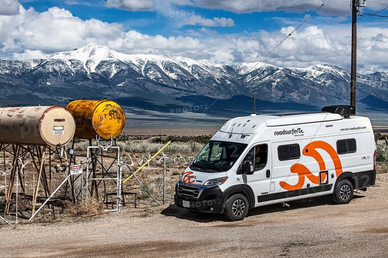 Motorhome parked in front of truck stop with oil barrels and a fence of deer antlers, Highway 50, Loneliest Road in America, Ely, Nevada, USA, North America