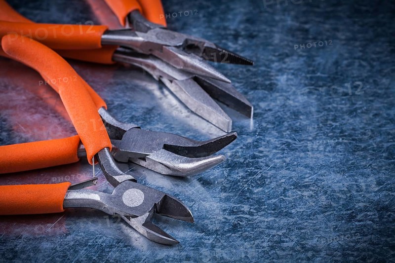 Collection of insulated cutting pliers gripping tongs with rubber handles