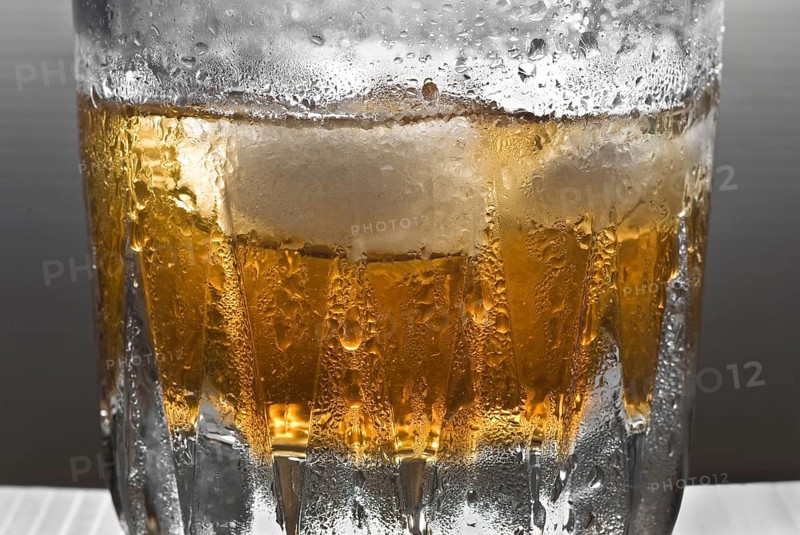 Drinks, shimmering glass of whisky with ice