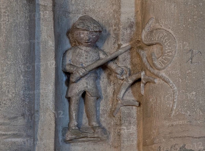 Zeitz Cathedral 78823 Main construction period 15th century small figure on the south gallery with whip and chariot drawbar labelled ICH HEIßE KÄSELIEB after a high medieval legend