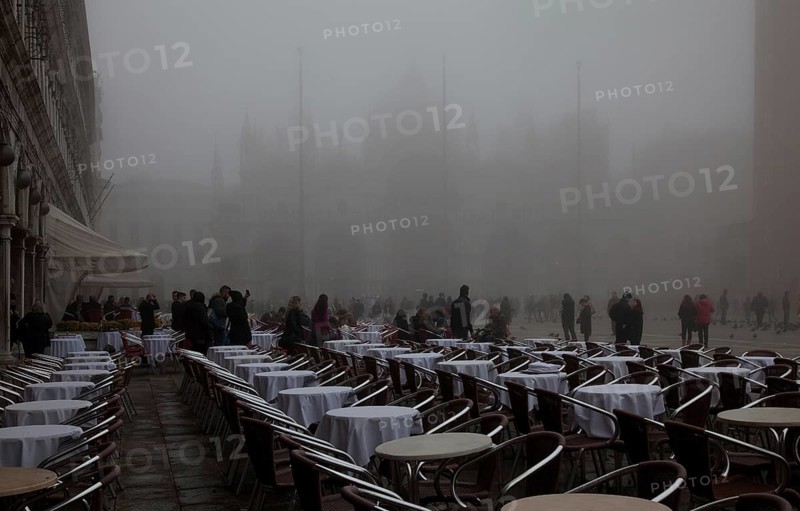 Italy Venice St Mark's Square -50 Café Lavena outdoor seating on a foggy November day behind St Mark's Basilica and Campanile