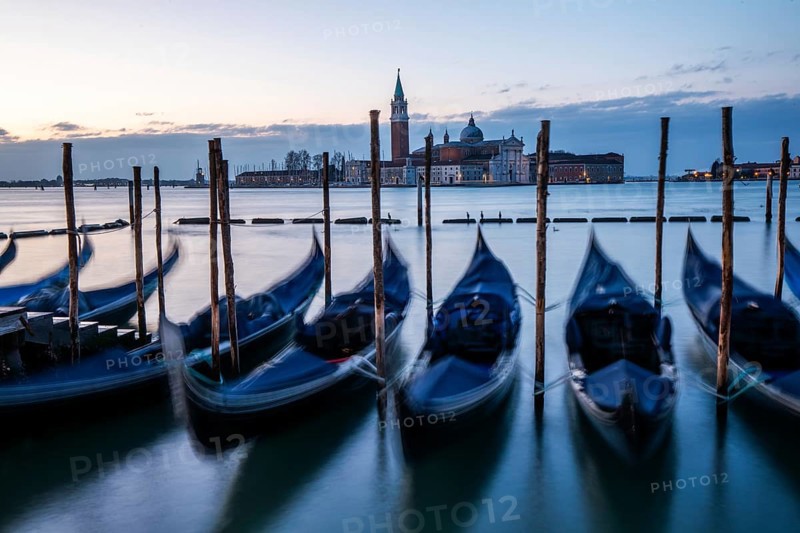Morning light in front of sunrise, Venetian gondolas, boat dock at St Mark's Square, church of San Giorgio Maggiore in the background, Venice, Veneto, Italy, Europe