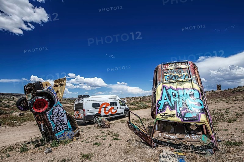 Motorhome and scrap cars decorated with graffiti in the Carforest of Goldfield, Nevada, USA, North America