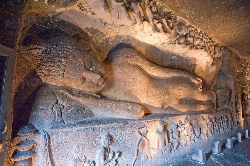 Huge figure of reclining buddha laying back in preparation for nirvana at ajanta caves, Aurangabad, Maharashtra, India, Asia